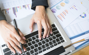Business Woman's Hands Typing On Laptop Keyboard