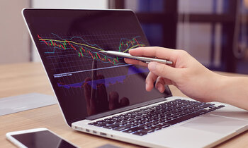 close up of hand pointing at a laptop screen